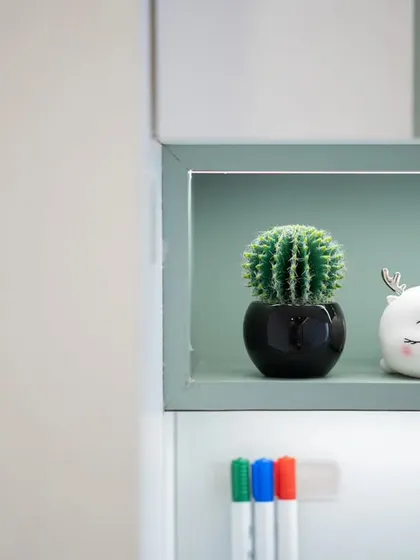 Even the smallest details are thoughtfully chosen. A cute cactus and a deer-faced decor piece add a playful touch to the study nook shelf.