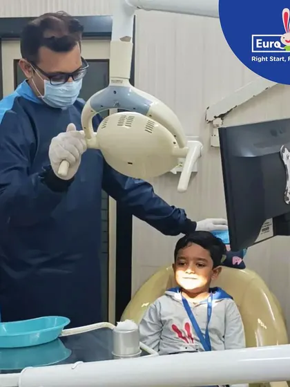 A close-up of a child getting a friendly check-up from the dentist. We prioritize hands-on learning to teach children about health and the community helpers who care for us.