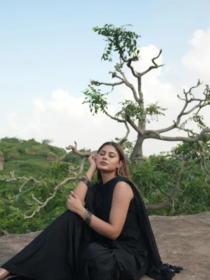 A serene, full-length shot of the model with her eyes closed, enjoying the peaceful natural surroundings.