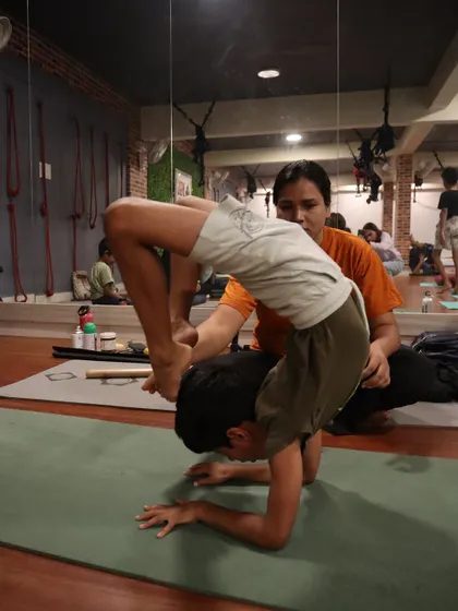 With my guidance, this young student explores a deep scorpion pose on his forearms. This advanced backbend requires a great deal of shoulder and spinal mobility, which we build up safely over time.