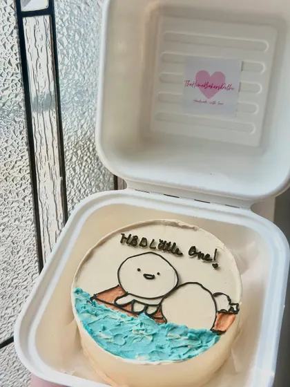 A cute and simple bento cake with a minimalist character design. Perfect for celebrating a little one or just sending a sweet message.