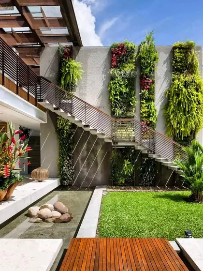 Our work complements modern architecture. For this home, we designed a subtle water channel that runs alongside the lawn and wooden deck, perfectly integrated with the home's clean lines and the stunning vertical gardens we also installed.