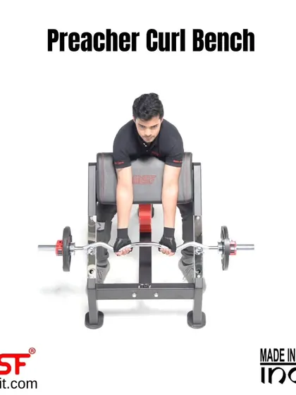A user at the start of the preacher curl movement.