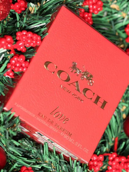 A close-up of the Coach "Love" perfume box, highlighting the luxury brand and making it a truly special gift.