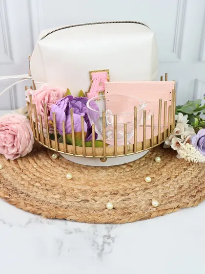 Another beautiful option for a bridesmaid gift, this hamper is presented in a gold wire basket. It includes a personalized pouch and other curated items, making it a stylish and practical present.