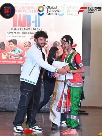 A proud moment for a classical dancer as she receives her award on stage at the Band-It competition in Bangalore.