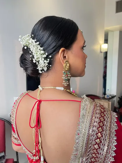 A side view of the soft twist bun, showing its clean lines and the delicate placement of the baby's breath.