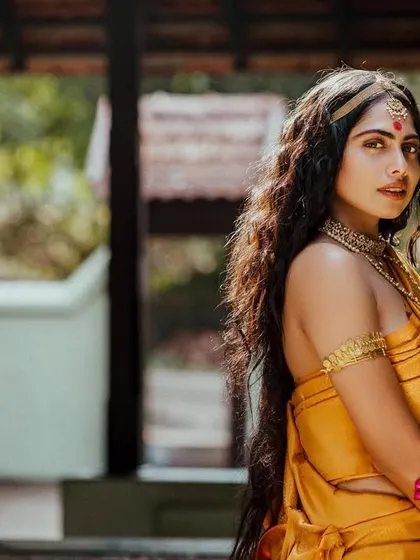 This shot from 'Thamara' captures the model in a traditional Kerala architectural setting, enhancing the cultural context.