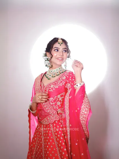 A close-up of our bright pink lehenga, paired with a stunning green necklace for a beautiful contrast.