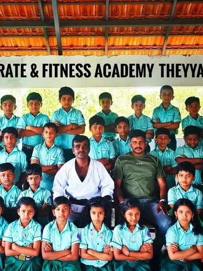 Another powerful group photo from the Theyyangad dojo, with students standing with their arms crossed, showing focus and readiness.