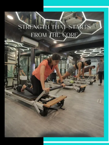 Clients hold a challenging plank position on the Reformers, demonstrating the core strength that is central to my Pilates method. The focus and determination are clear.