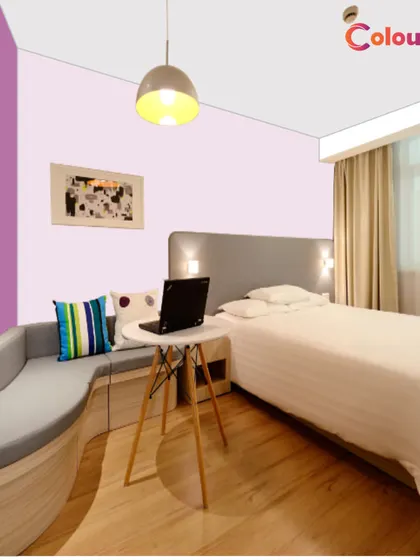 This image from our color visualizer tool shows a guest room with a modern purple and lilac color scheme. You can use our online tools to find the perfect shade combination before our expert painters bring it to life.