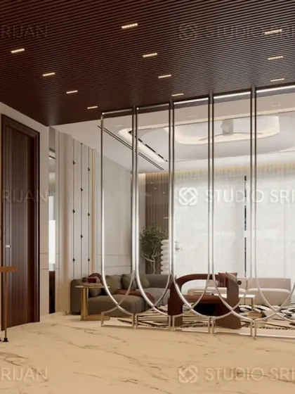 A decorative screen made of polished metal loops separates the living and dining areas in this Model Town home, acting as a functional piece of art.