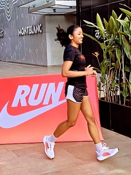 Running past a Nike banner as a pacer. It's a privilege to lead and motivate fellow runners in our city.
