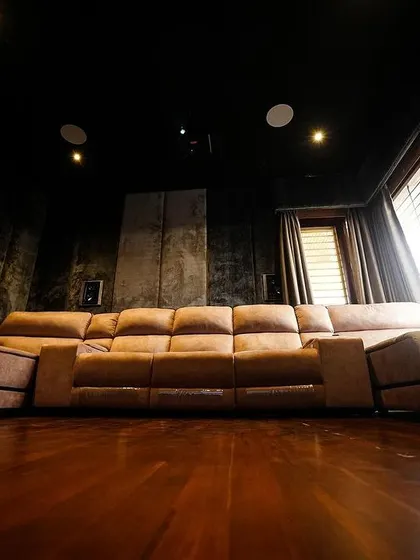 A duplicate of 240, this low-angle shot emphasizes the spaciousness of the room and the comfort of the large sofa.