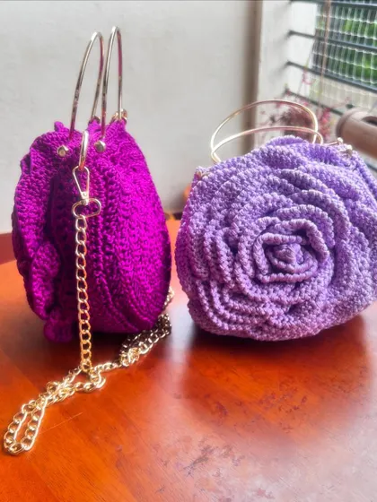 A side-by-side comparison of the magenta and lavender Rose Bags, both featuring a detachable gold chain.