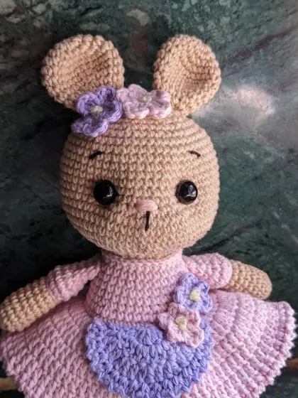 A portrait shot of the dressed-up bunny amigurumi.