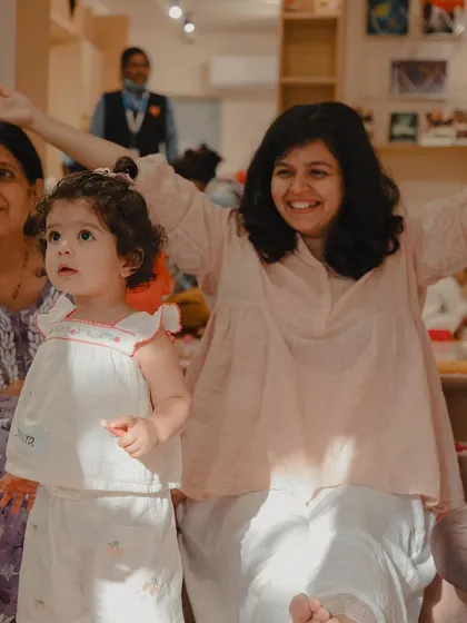 A mother and child share a joyful moment at our Holi event. This image captures the essence of our family-friendly celebrations.