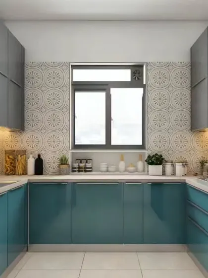 A U-shaped modular kitchen that makes excellent use of space. The combination of glossy teal lower cabinets and grey upper cabinets, paired with a decorative tile backsplash, creates a vibrant and functional kitchen.