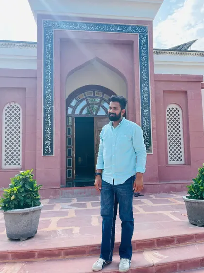 Standing before a beautiful mosque, the sun casting a glow. I am always ready to serve my motherland, even if it demands the ultimate sacrifice.