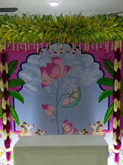 A closer look at the vibrant colors of this Pichwai backdrop. The combination of pinks, blues, and greens creates a lively and artistic setting.