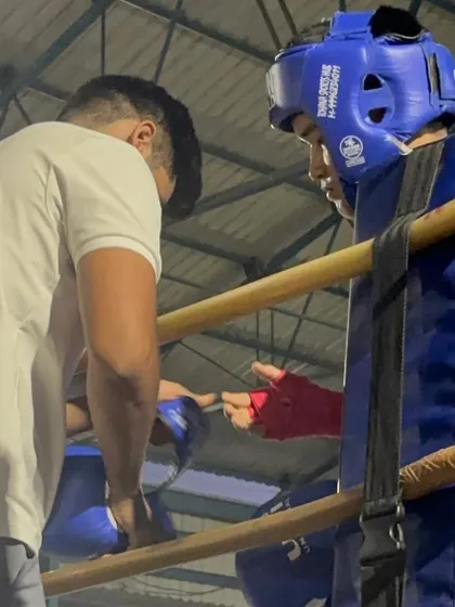 A close-up moment in the corner. Communication and trust between a coach and a fighter are essential for success in the ring.