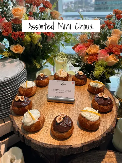 Sweet and savory perfection. These Assorted Mini Choux pastries are filled with delicious creams and topped with nuts, offering a delightful bite-sized dessert or a unique appetizer.
