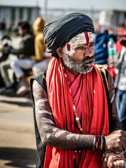Not every shot is a direct portrait. Much of my work is about capturing people as they are, living their lives. This candid moment on the streets of Varanasi shows a sadhu amidst the energy of the festival.