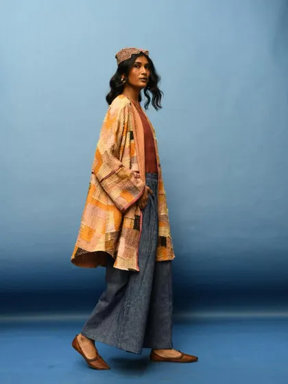 A profile shot in motion, capturing the beautiful movement of the jacket and pants. This image shows that slow fashion is made for a life in motion.