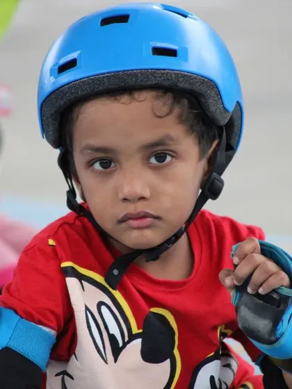 The focused expression of a young learner concentrating on his next move. Even our youngest students show incredible dedication during their skating lessons.