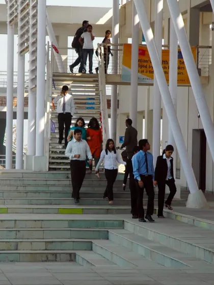 Another view of the staircase at Symbiosis, highlighting its role as a social artery. The open design and wide steps allow for easy flow and provide informal seating, reinforcing the campus's friendly and interactive character.