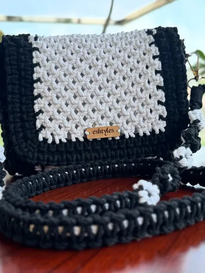 Another angle of the black and white sling bag with the floral strap. The details really make this piece special.