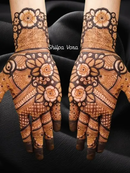 A full-coverage floral design with bold, shaded roses, perfect for a festive occasion like Teej.