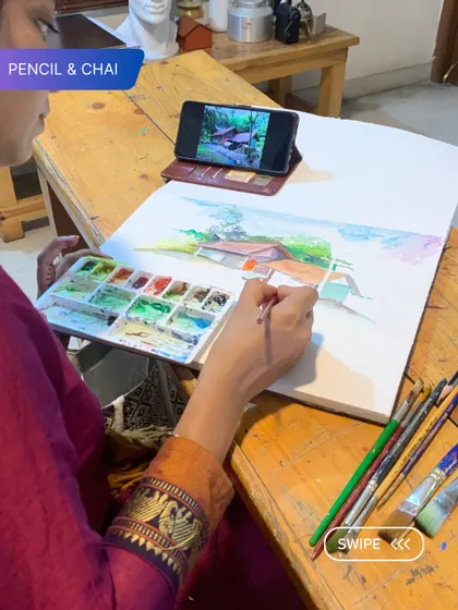 An instructor paints a landscape, demonstrating how to capture the essence of a scene with loose, expressive strokes. This is part of our hands-on teaching approach.