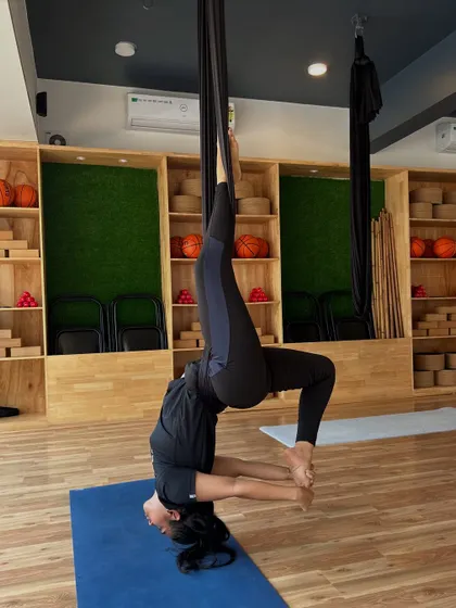 An advanced inversion in the aerial hammock, demonstrating incredible strength and flexibility. Our classes cater to all levels, from beginner to advanced.