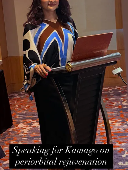 Speaking on Periorbital Rejuvenation. A photo of me at the podium, delivering a lecture for Kamago on the latest techniques for rejuvenating the delicate skin around the eyes.