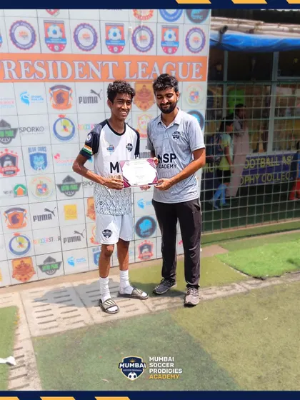 A player receives his award after the U15 match.