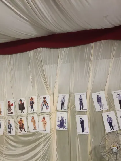 My exhibition wall featuring various celebrity caricatures at the Timeless Ayodhya Festival.