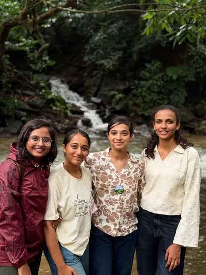A group of friends posing by a stream on the Bandaje trail.