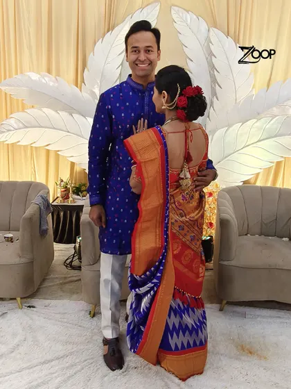A beautiful moment captured. This happy customer is celebrating his special day in a classic royal blue kurta, perfectly complementing his partner's traditional attire.