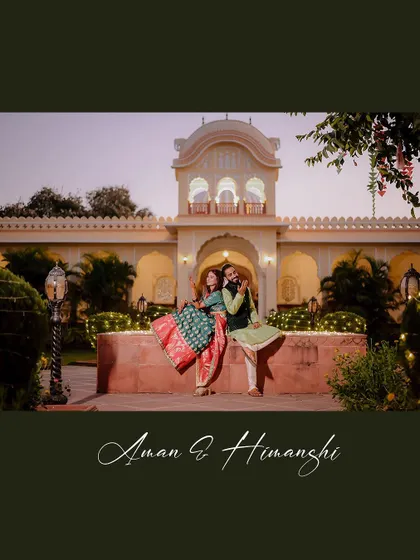A wide shot of the couple at their destination mehendi, showcasing the beautiful palace backdrop.
