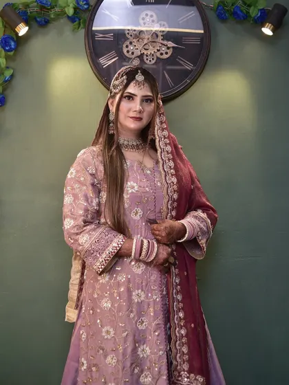 A poised and elegant stance. The bride's makeup, hair, and outfit all come together to create a picture-perfect look.
