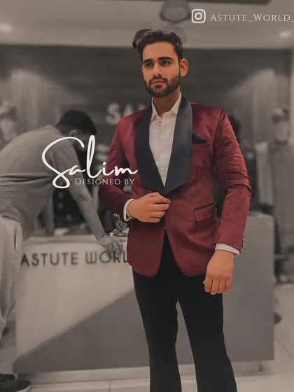 A client in a classic maroon velvet tuxedo jacket with a black shawl lapel. This is a rich and elegant choice for any formal winter event.