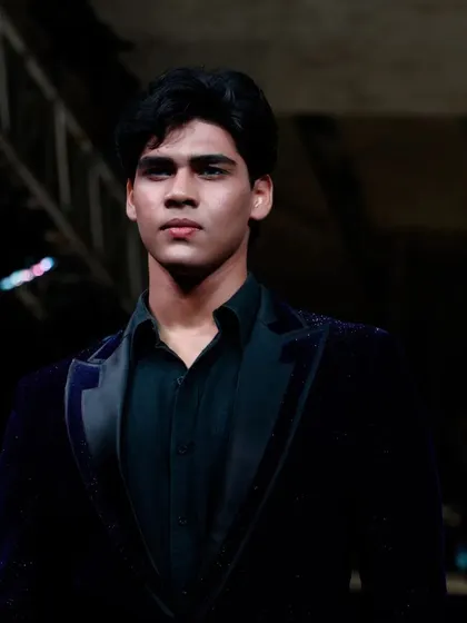 A portrait of a male model just before he takes the stage, capturing the focus and intensity of the backstage environment I manage.
