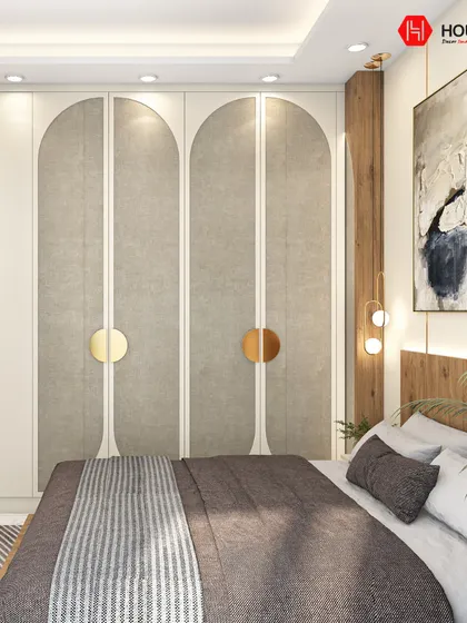 A close-up of the bespoke wardrobe in our modern elegance bedroom. The arched design, textured panels, and circular gold handles add a touch of luxury and uniqueness to the functional storage solution.