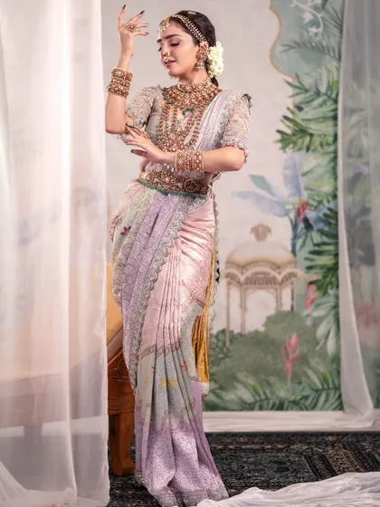 A portrait that feels like a painting. The model's graceful pose, combined with a beautifully draped pastel saree and a soft, artistic backdrop, creates a timeless and ethereal image.