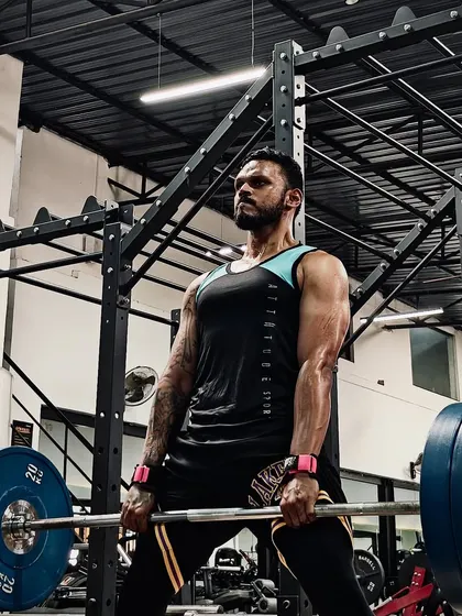 A close-up of a heavy sumo deadlift in progress. This lift requires immense grit and focus, embodying the mindset I work to instill in my athletes.