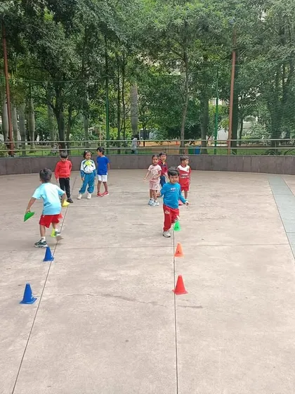 Little players navigate a cone drill, learning agility and ball control in a playful and encouraging environment.