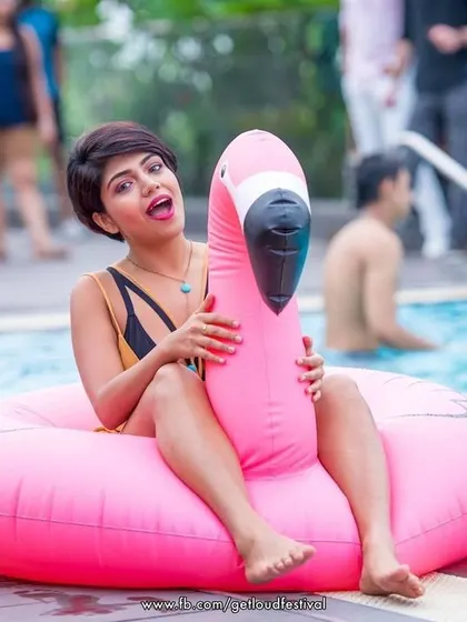 A guest having fun with a pink flamingo floatie at our Easter sundowner pool party.