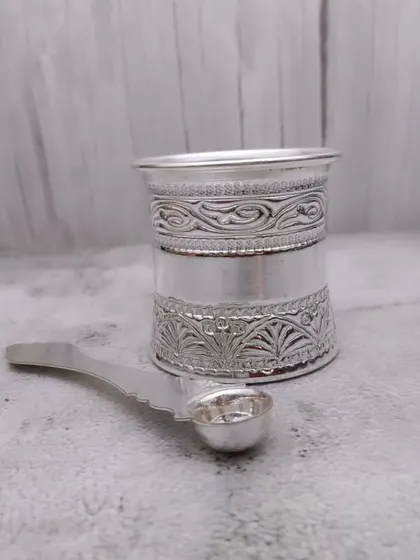 Another angle of the German silver panchapatra, showing the fine engravings on the glass.